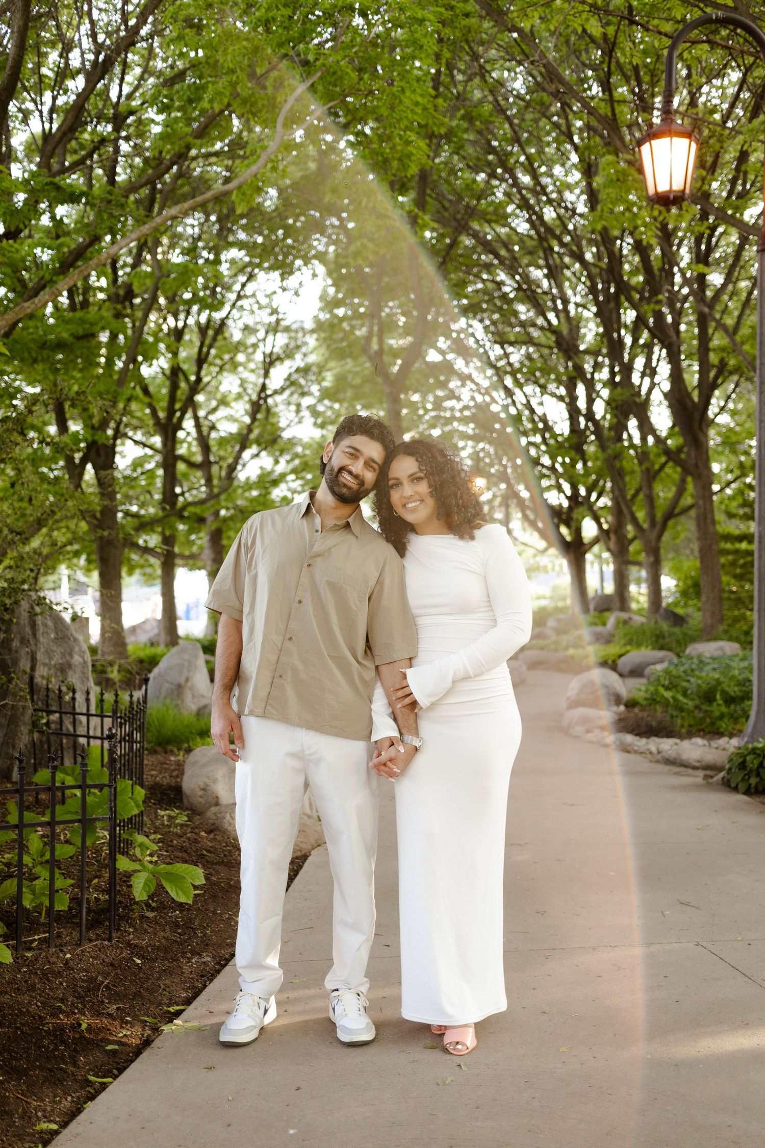 Fiancés standing in the Toronto Music Gardens together for their engagement photos.
