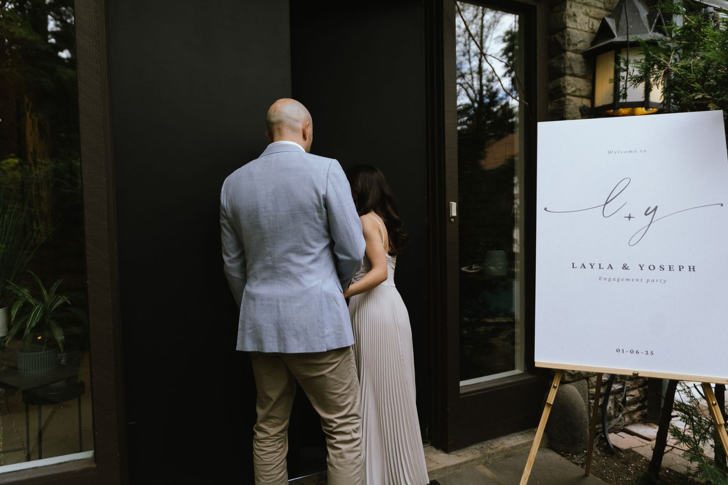 Fiancés walk in to their engagement party together.