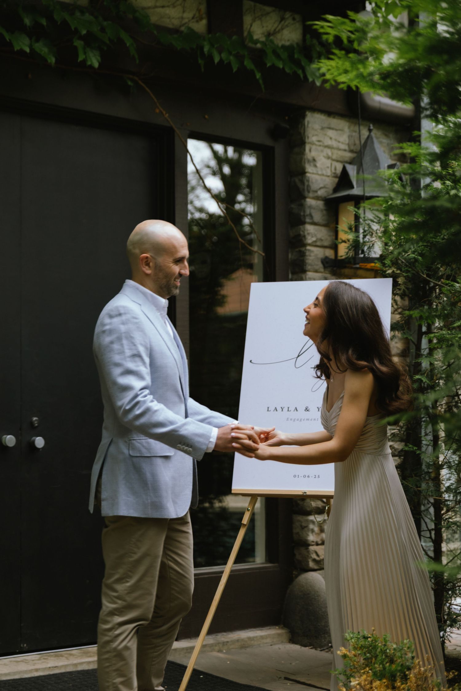 Fiancés walk in to their engagement party together.