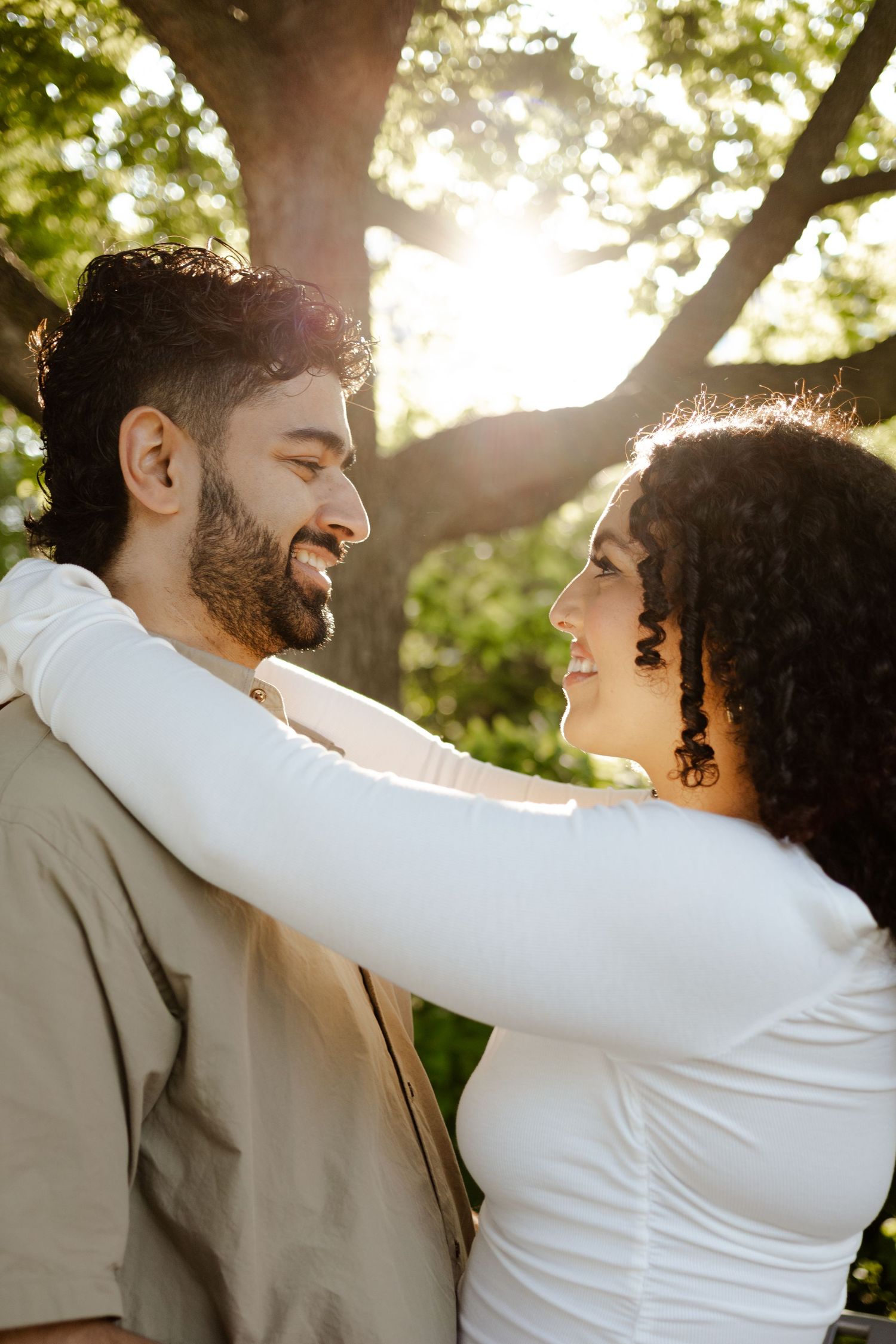 Fiancés standing in the Toronto Music Gardens together for their engagement photos.