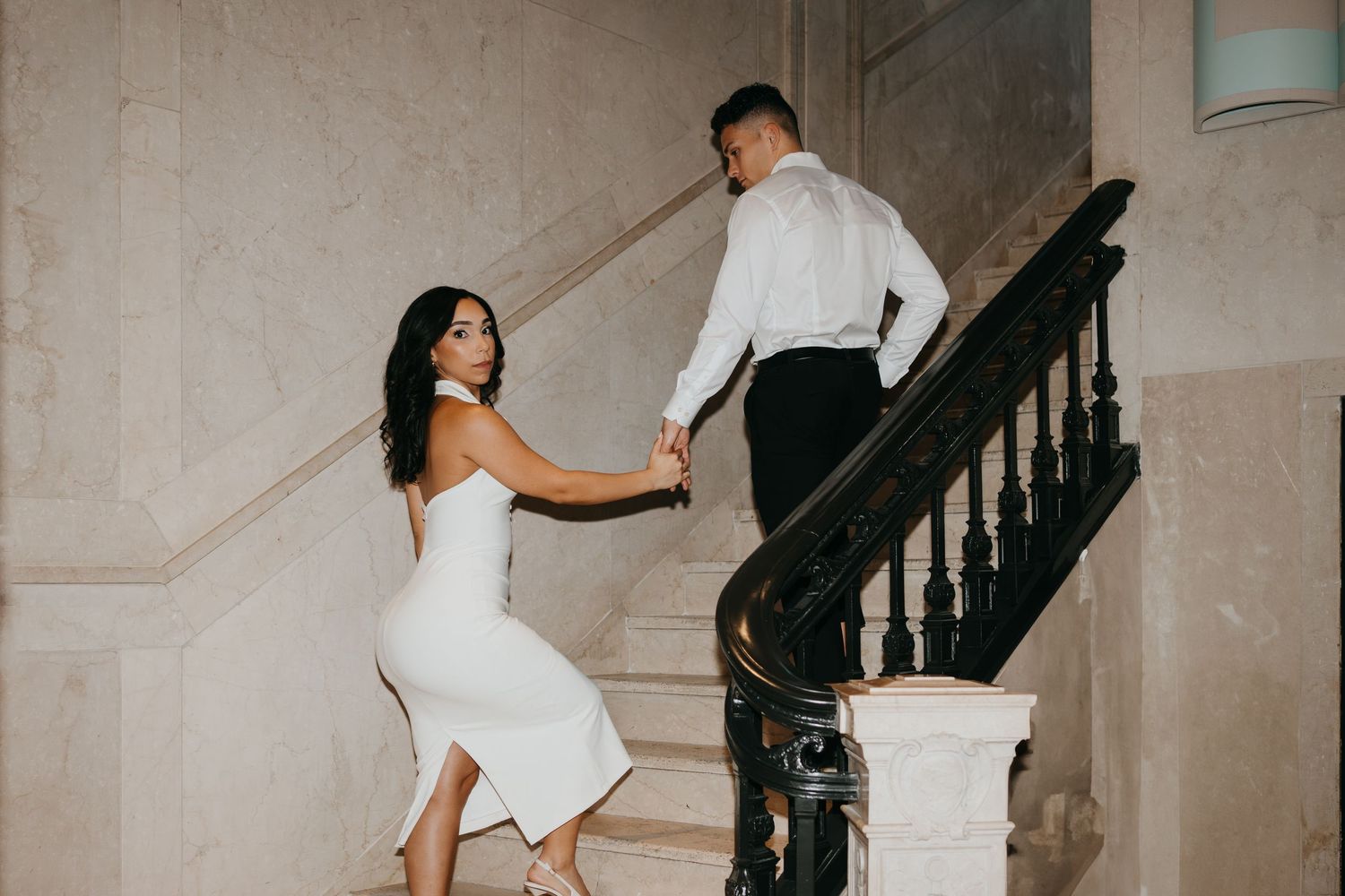 Artistic sequence shows people ascending a grand staircase in formal wear.