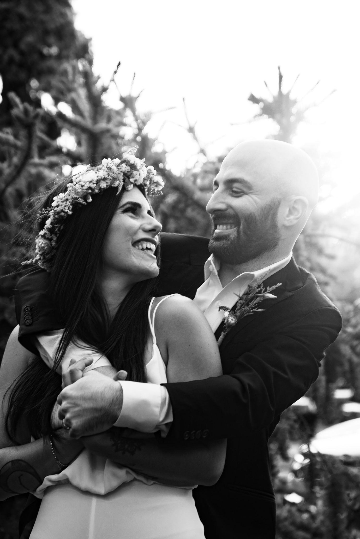 Black and white wedding photos capturing intimate moments and laughter between newlyweds.