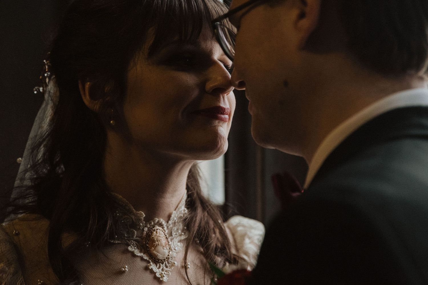 Moody wedding portraits in dark lighting showing intimate romantic moments.