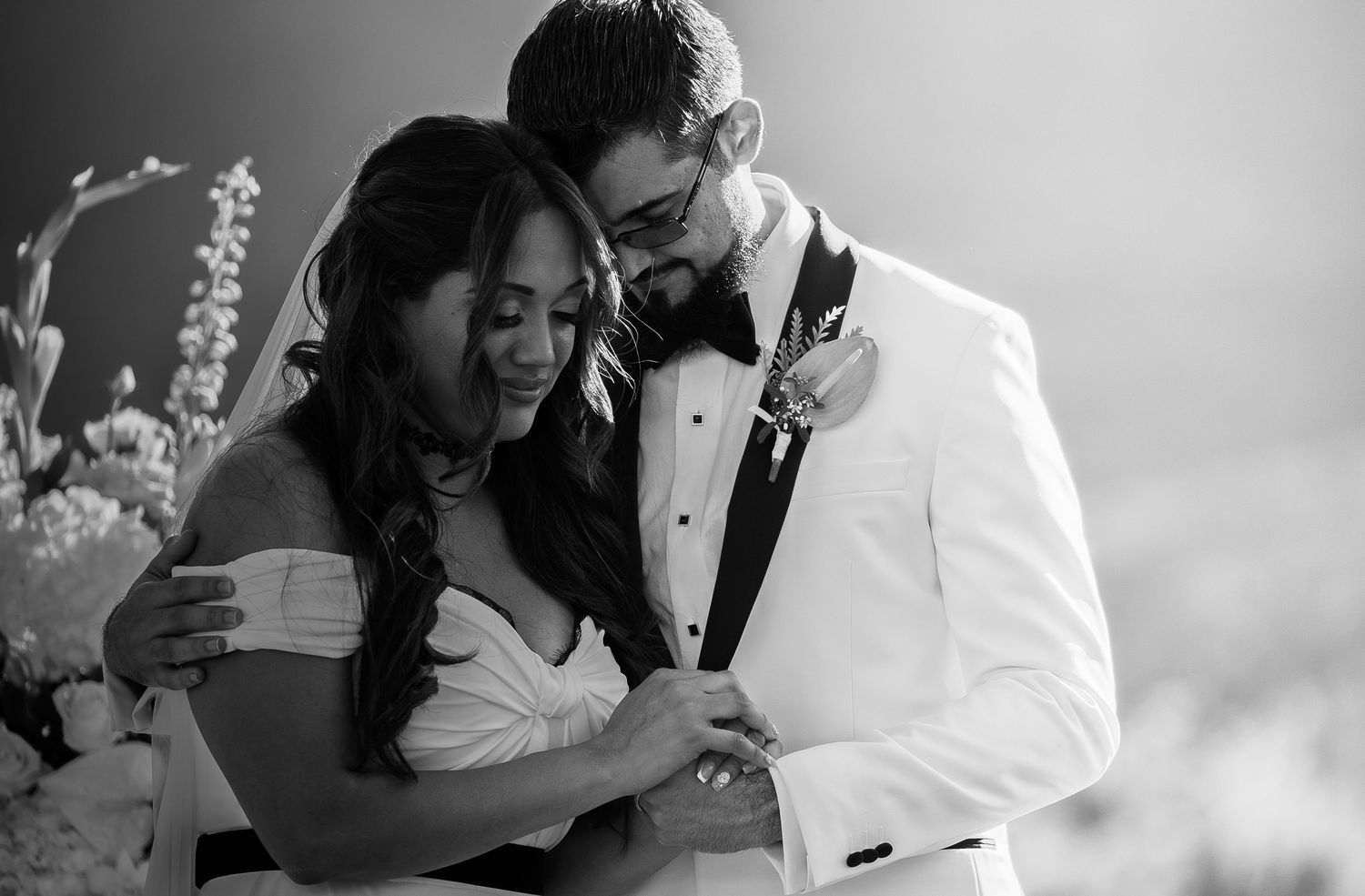 A series of black and white wedding photos showing romantic moments between couples during their celebrations.