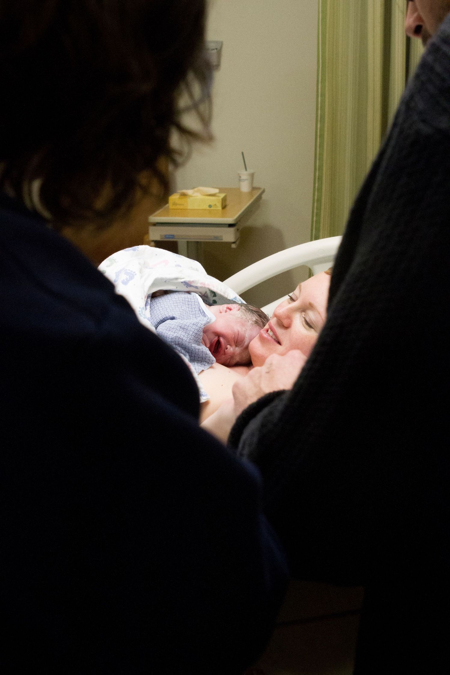 grandmother supporting family during birth in hospital