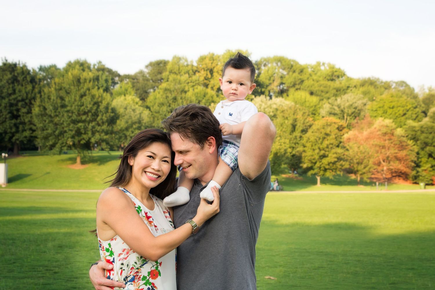 father admiring mother with son on shoulders