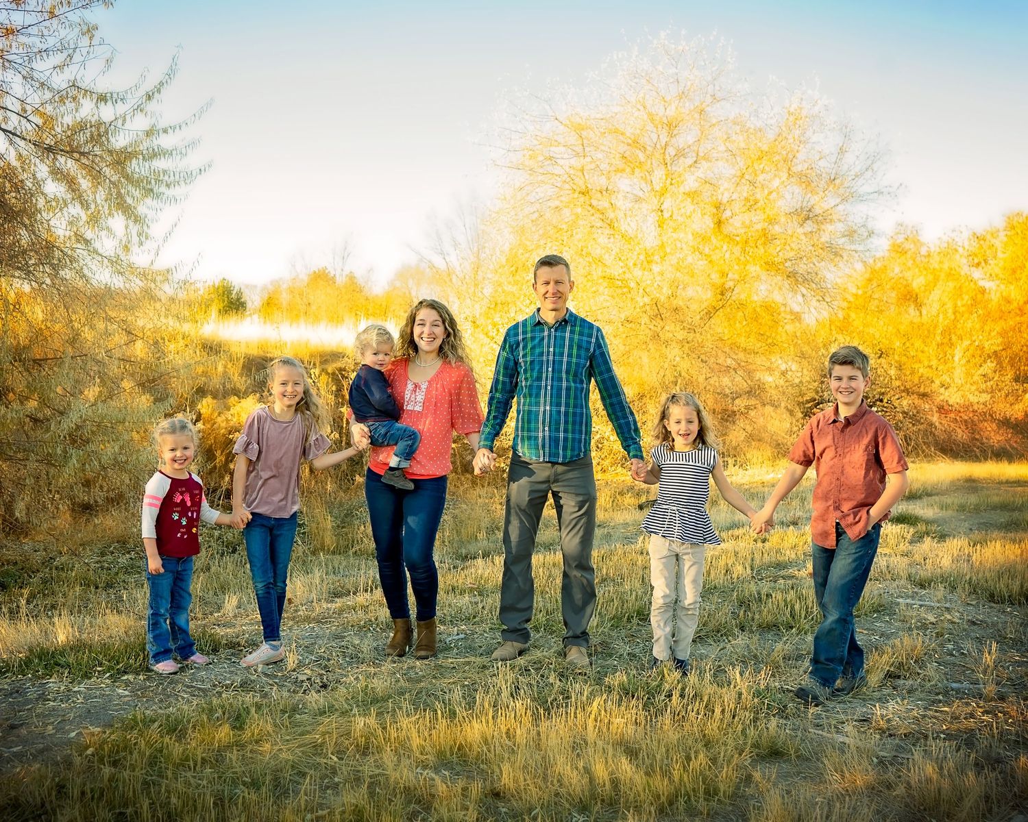 family walking together during sunset photo session
