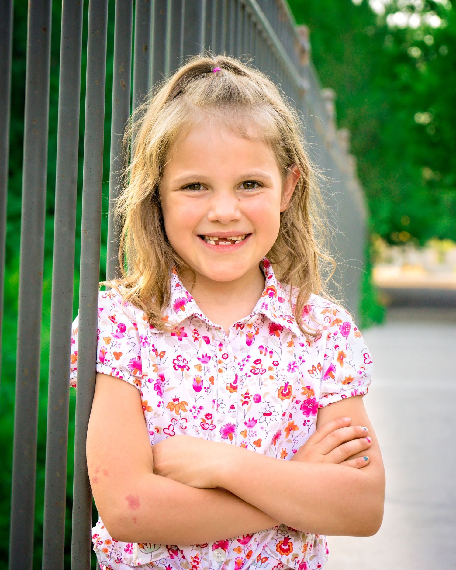 little girl smiling on bridge