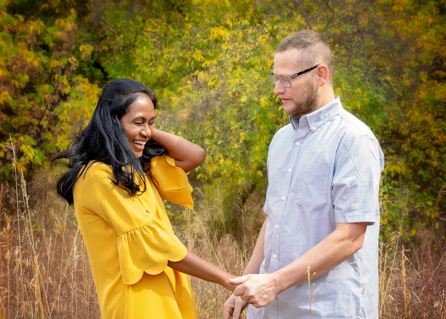 couple laughing in field