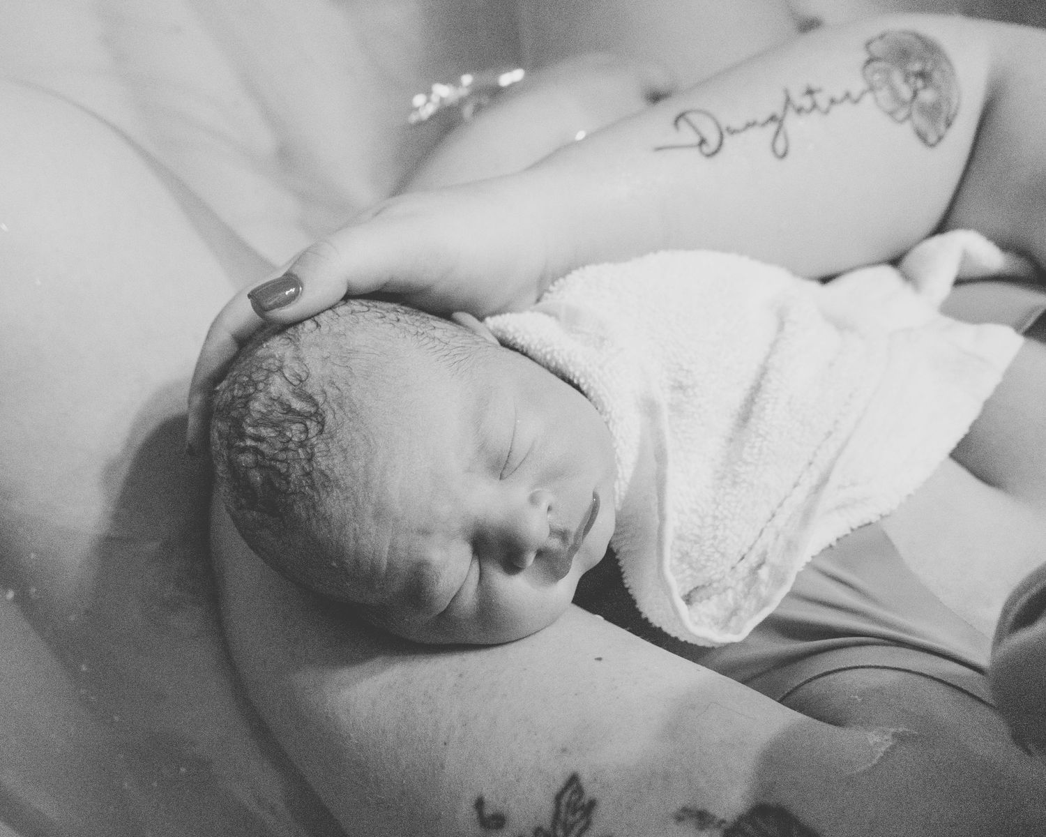 mother holding newborn baby skin to skin after birth