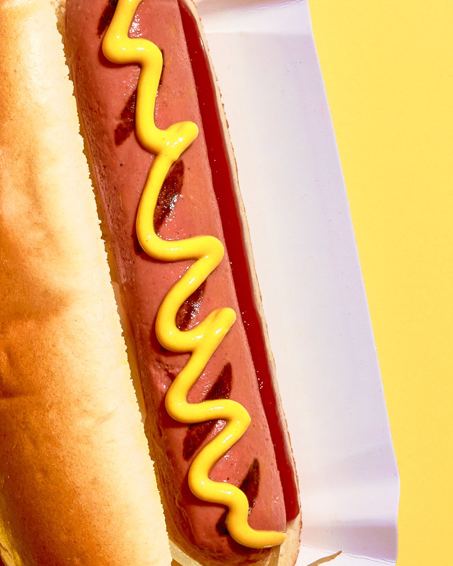Hot dog with mustard decoration - Vegan alt meat food photography London - Nancy Anne Photography - Commercial food photographer