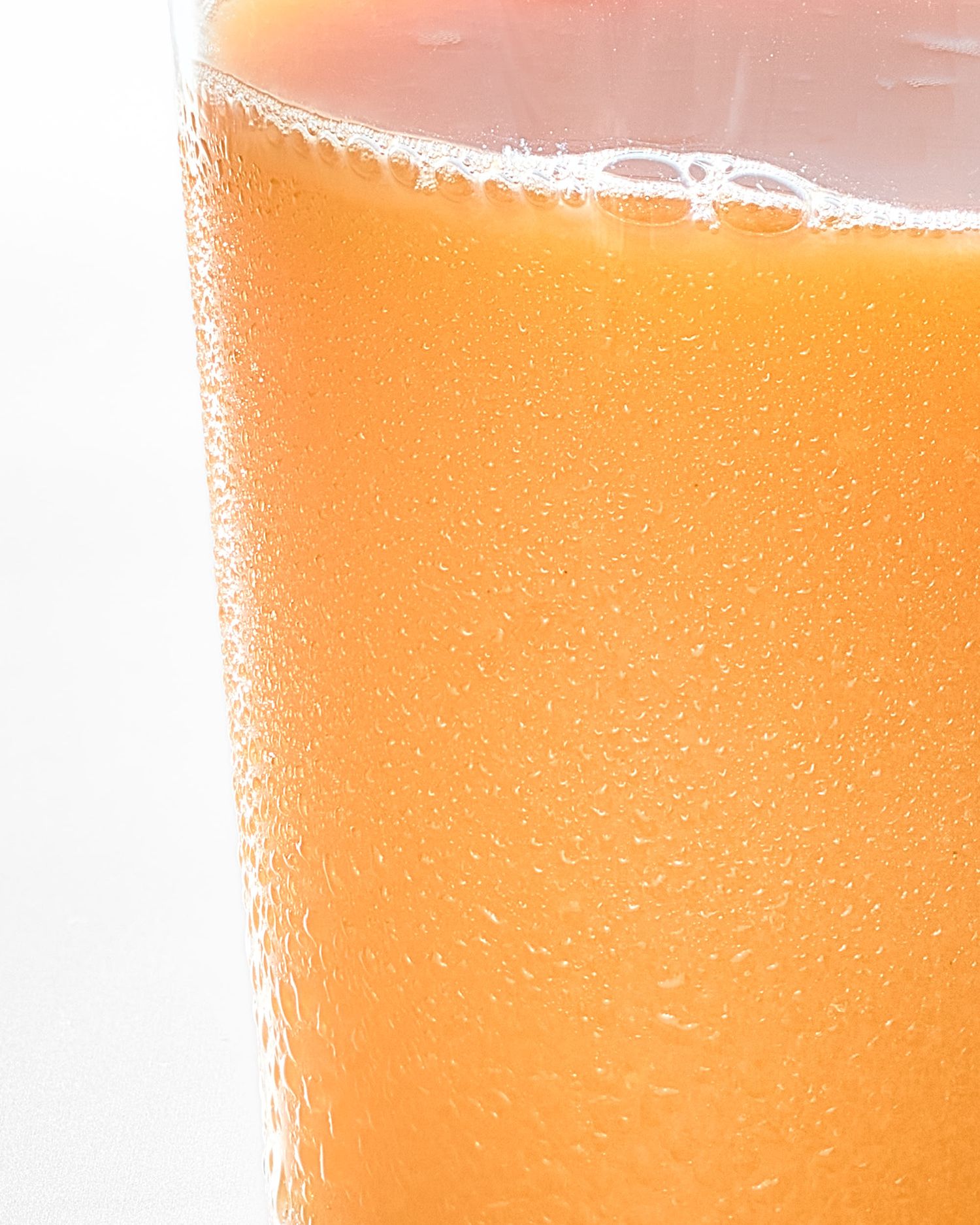 Orange juice glass with condensation - commercial drink photography - Nancy Anne - food photographer London