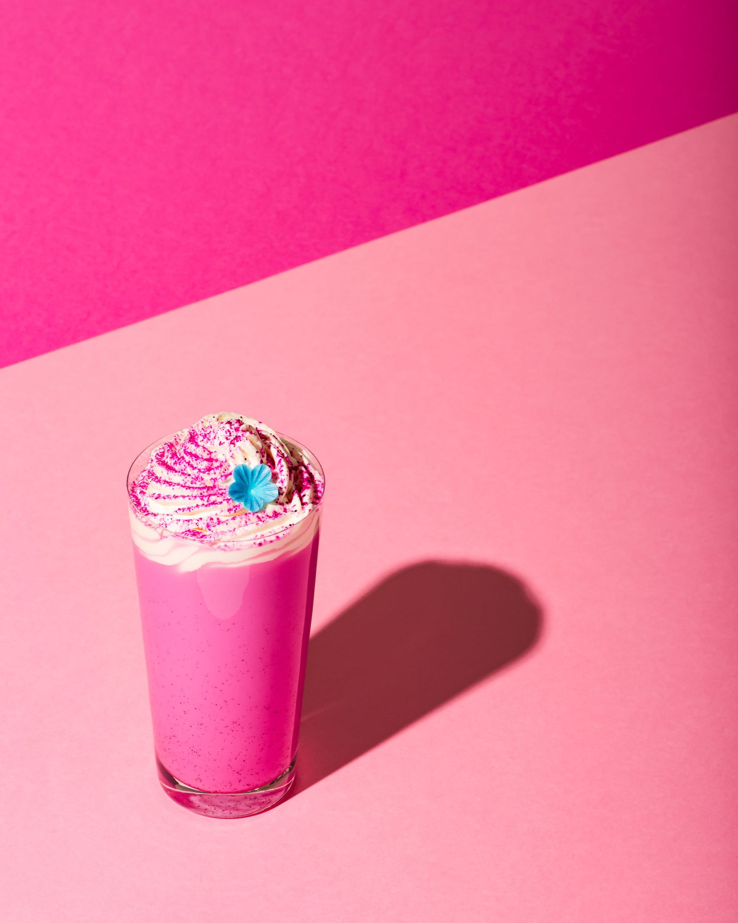 Pink milkshake with whipped cream  - pink creative coffee shop photography - Nancy Anne - drink photographer London