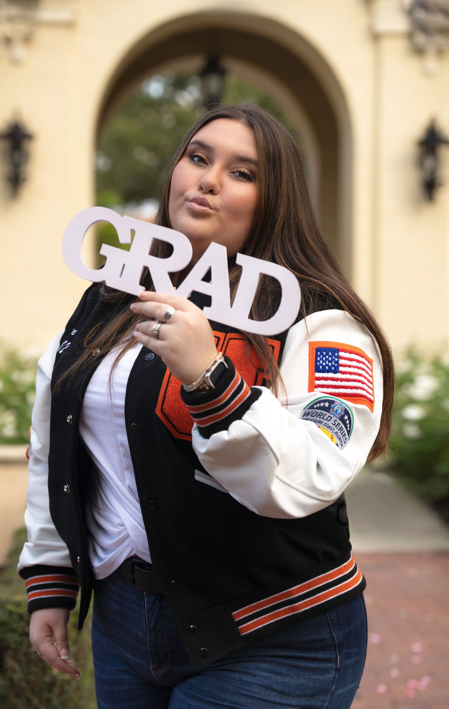 Graduation photo series with GRAD letters and varsity jacket.