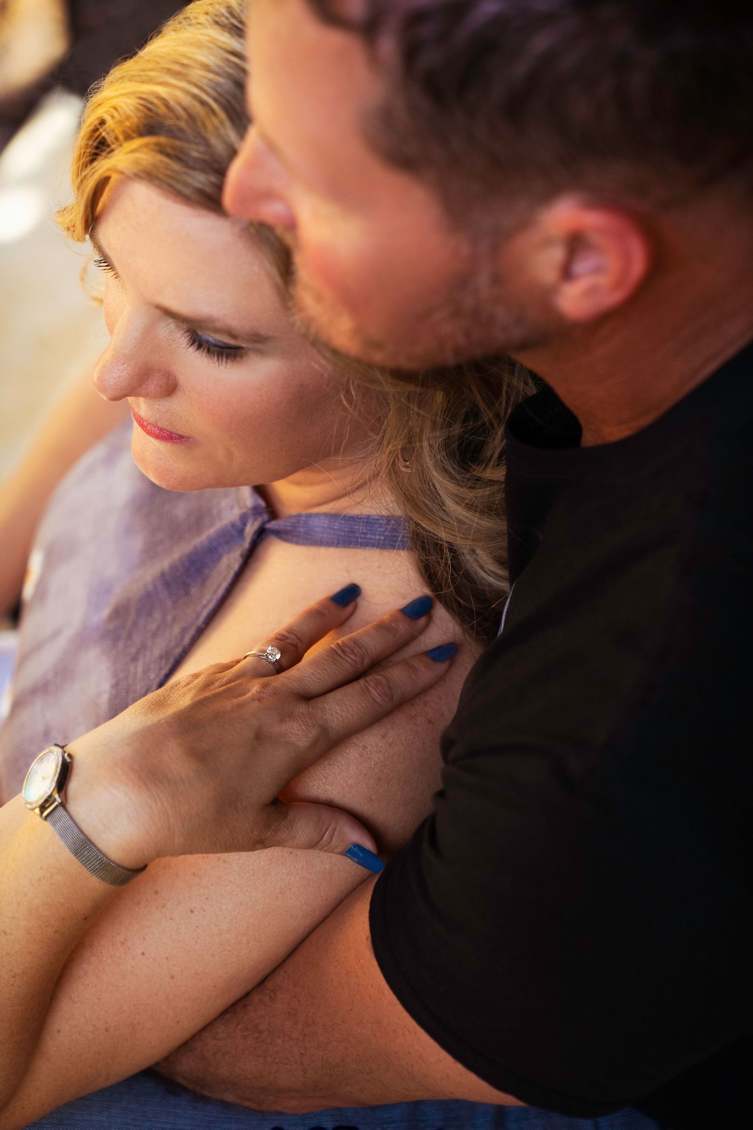 Close-up series of intimate couple embracing and touching in romantic low-light setting.