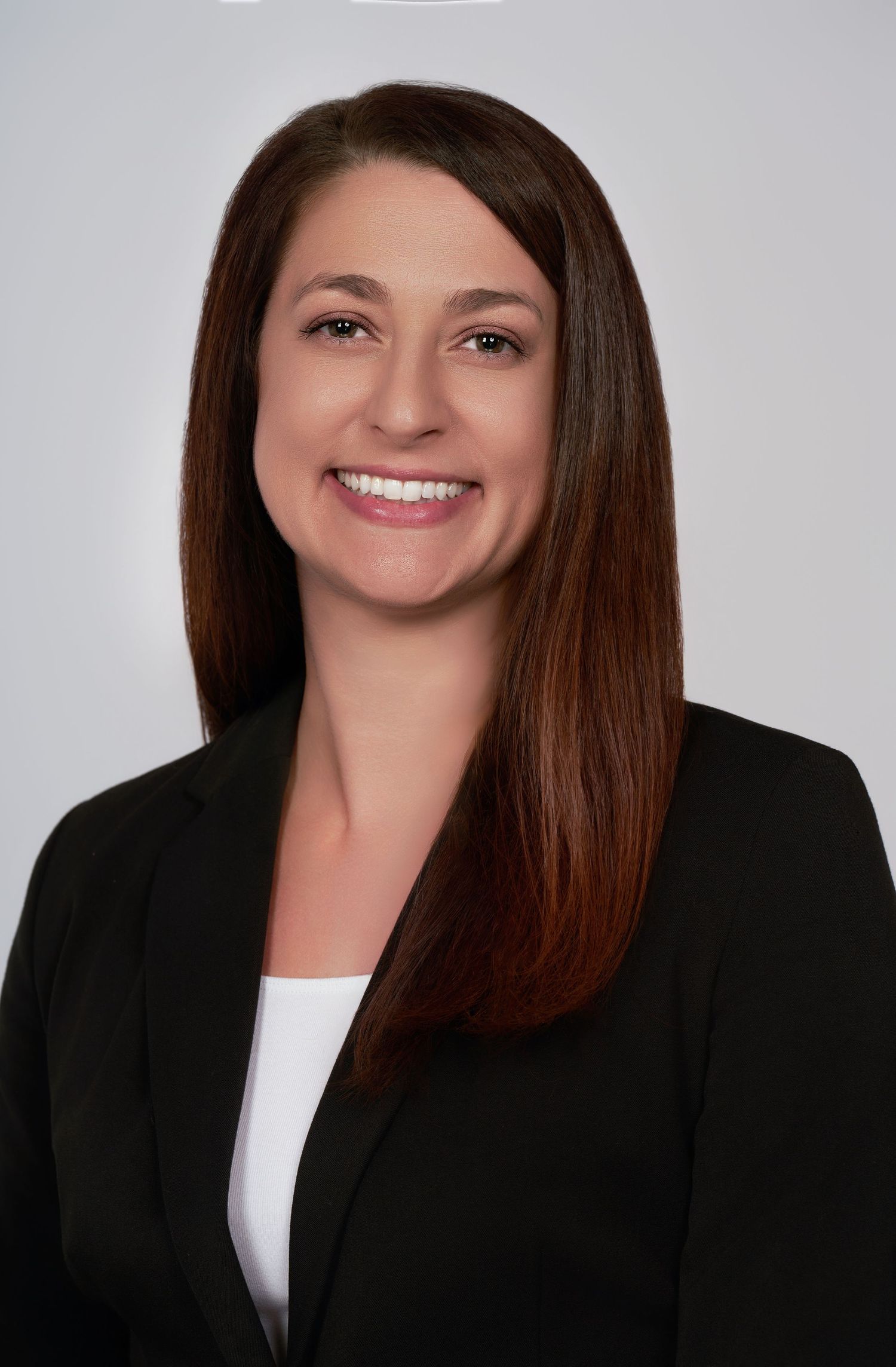 Professional headshots in business attire against a light gray studio background.