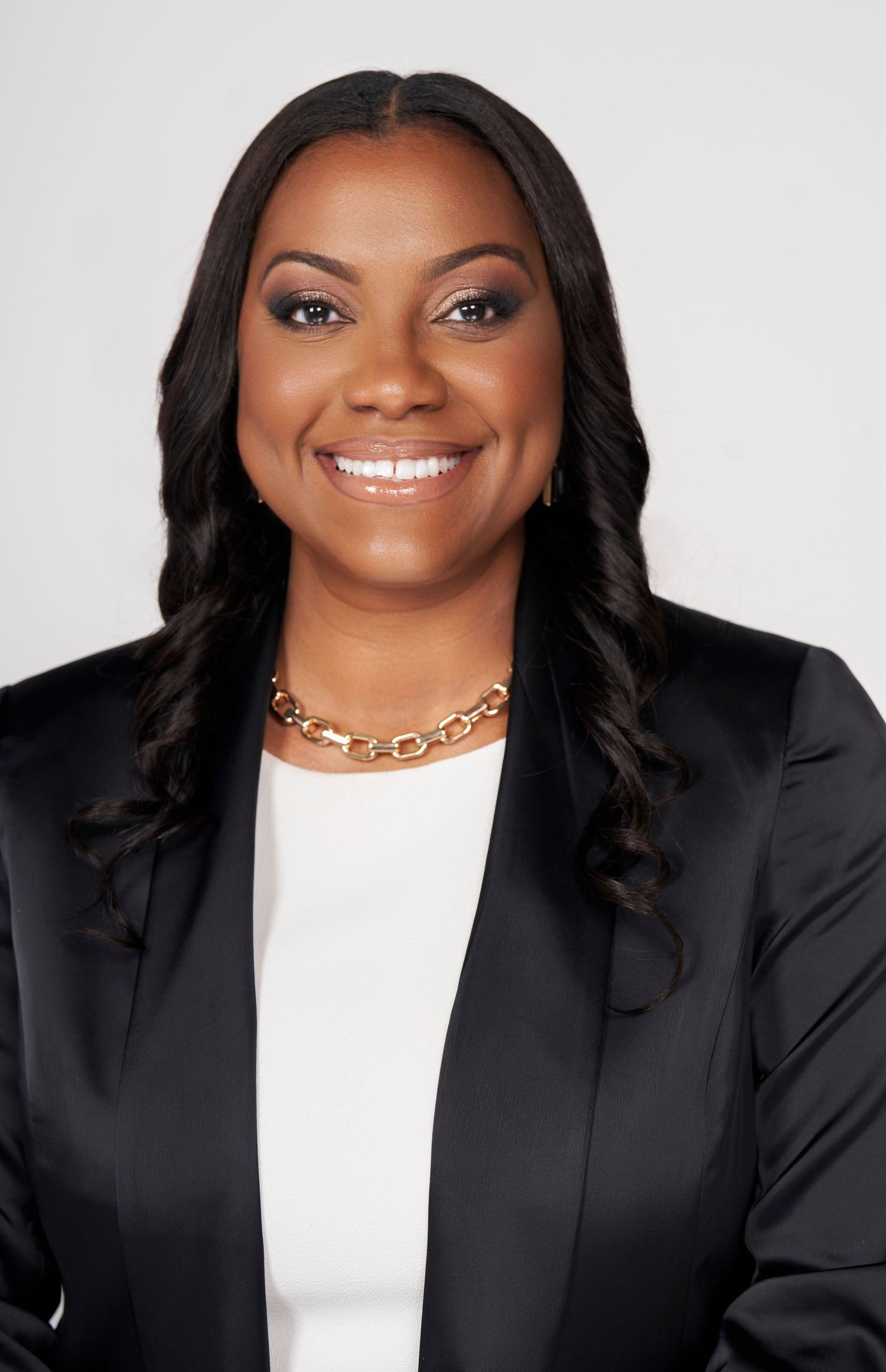 Professional headshot series showing confident smile and business attire against neutral backdrop.