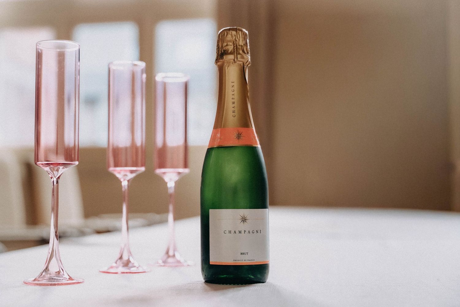 3 glasses with a champagne bottle