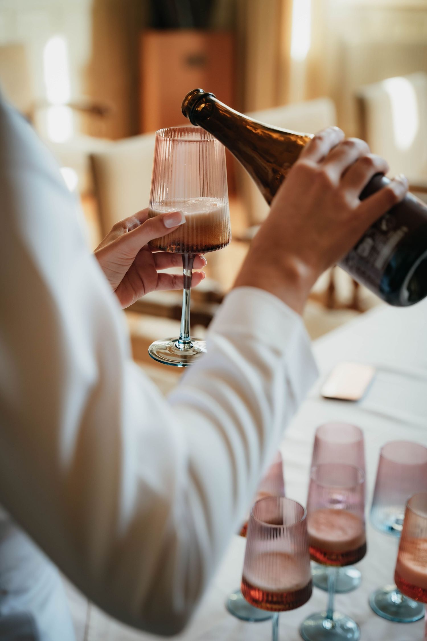 PhD candidate pouring a glass of wine