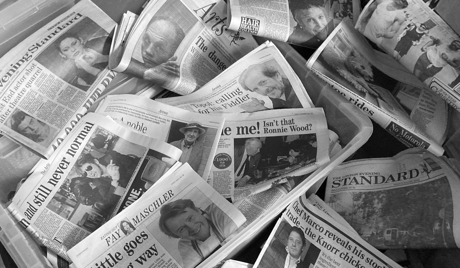 Newspapers cuttings scattered together, including The Standard, with visible headlines and photographs by Photographer Danny Elwes