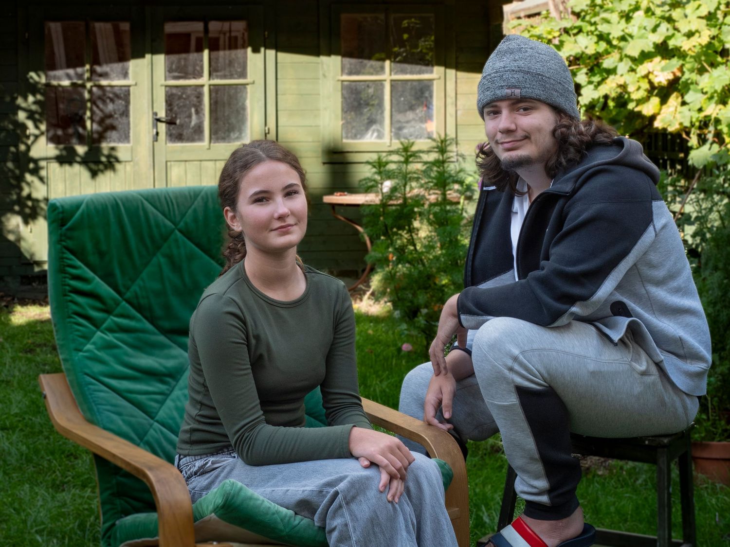 Brother and sister sitting in their garden for family portrait for 'Before they Fly the Nest'
Photograph by Danny Elwes