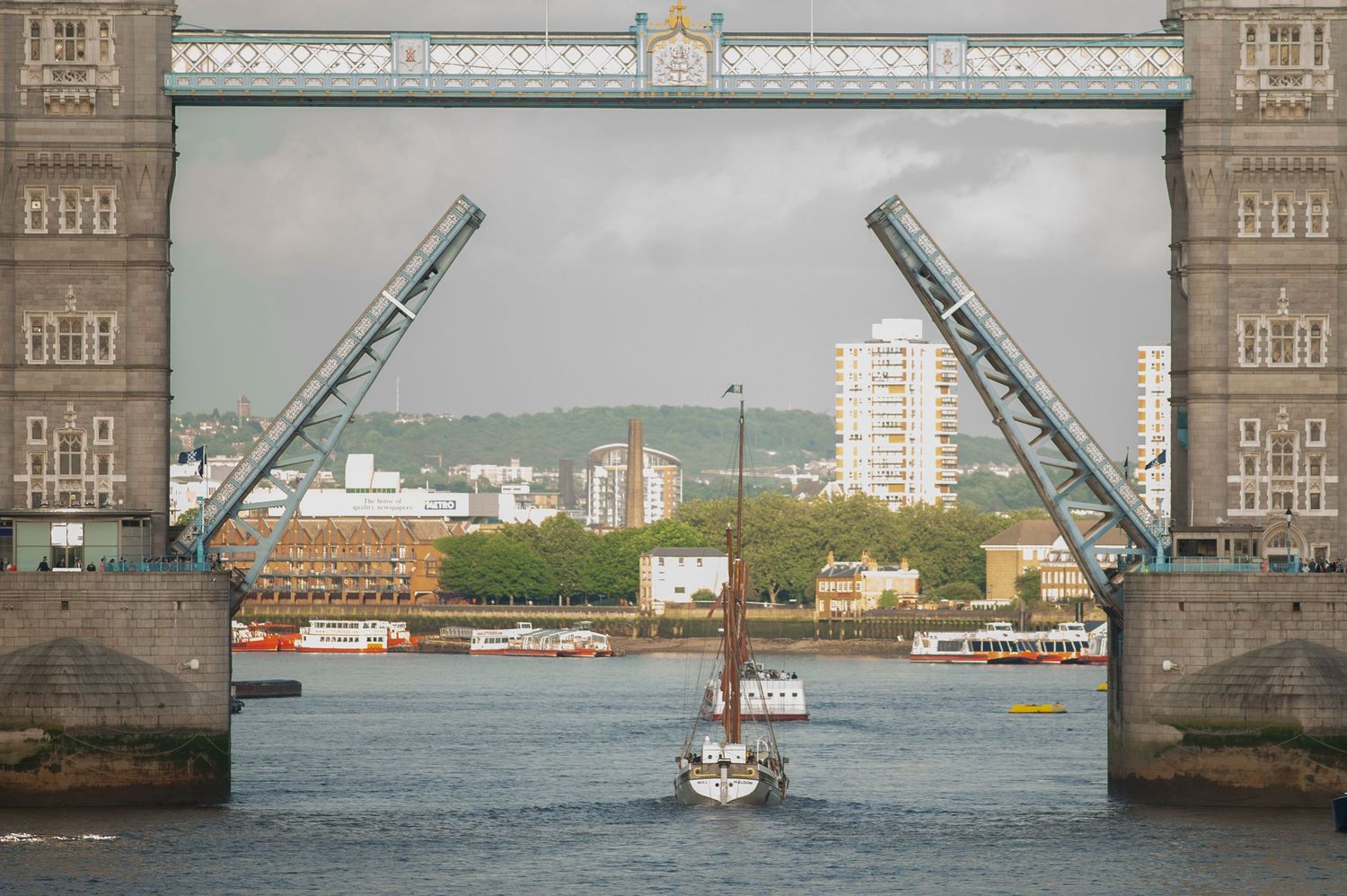 Tower Bridge raised for passing sailing yacht. London Photo Tour photographing tourists on holiday
Photograph by Danny Elwes