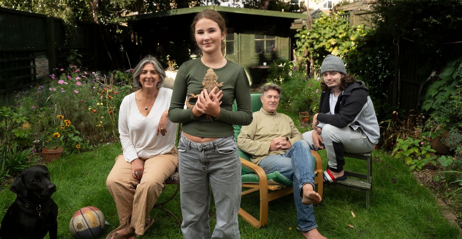 Family in their garden for portrait for 'Before they Fly the Nest' With family pets, Bearded Dragon and dog
Photograph by Danny Elwes