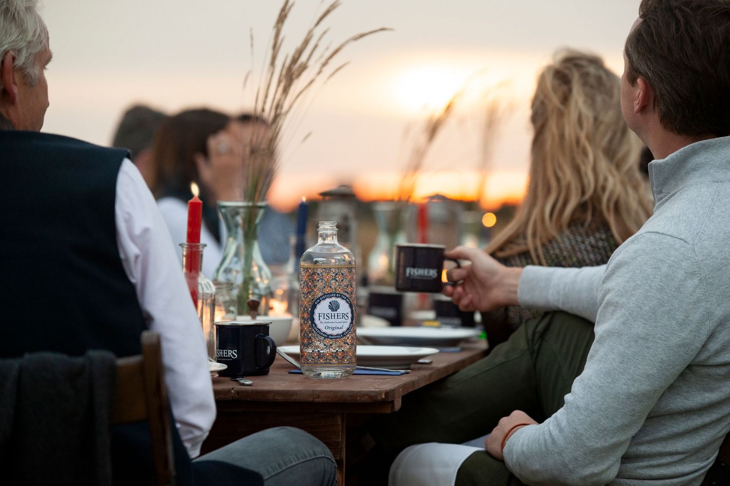 People enjoying drinks at outdoor table during sunset. Fishers Gin photo shoot Suffolk coast
Photograph by Danny Elwes