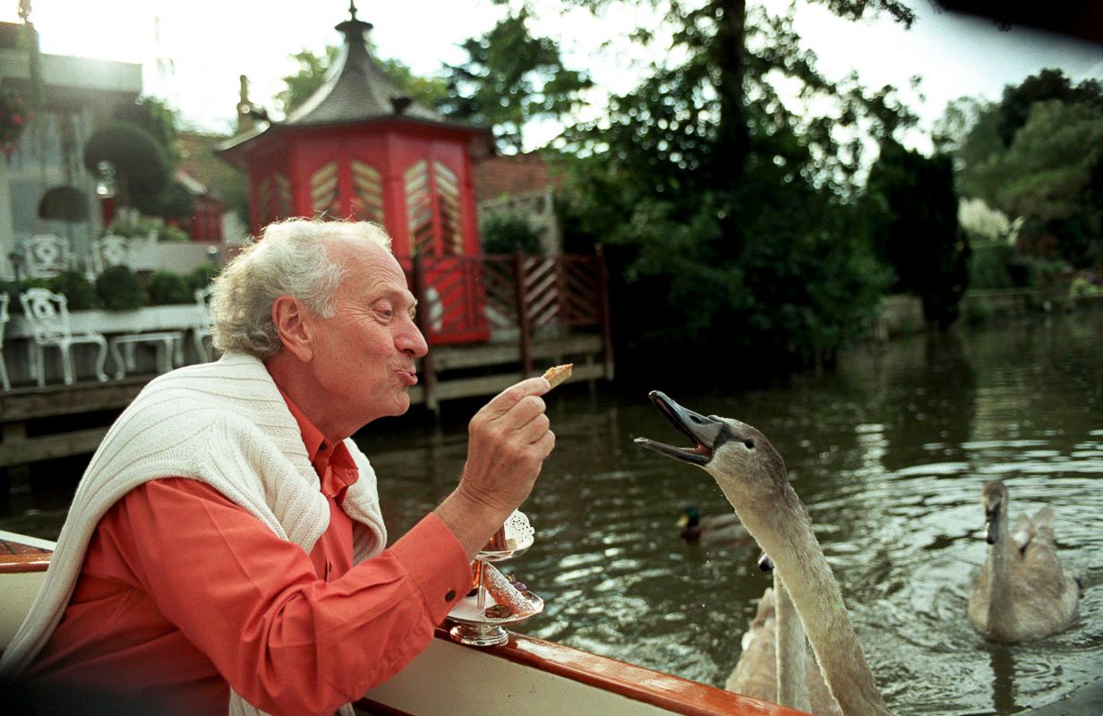 Michel Roux Snr feeding the swans outside his restaurant The Waterside Inn Bray
Photograph by Danny Elwes