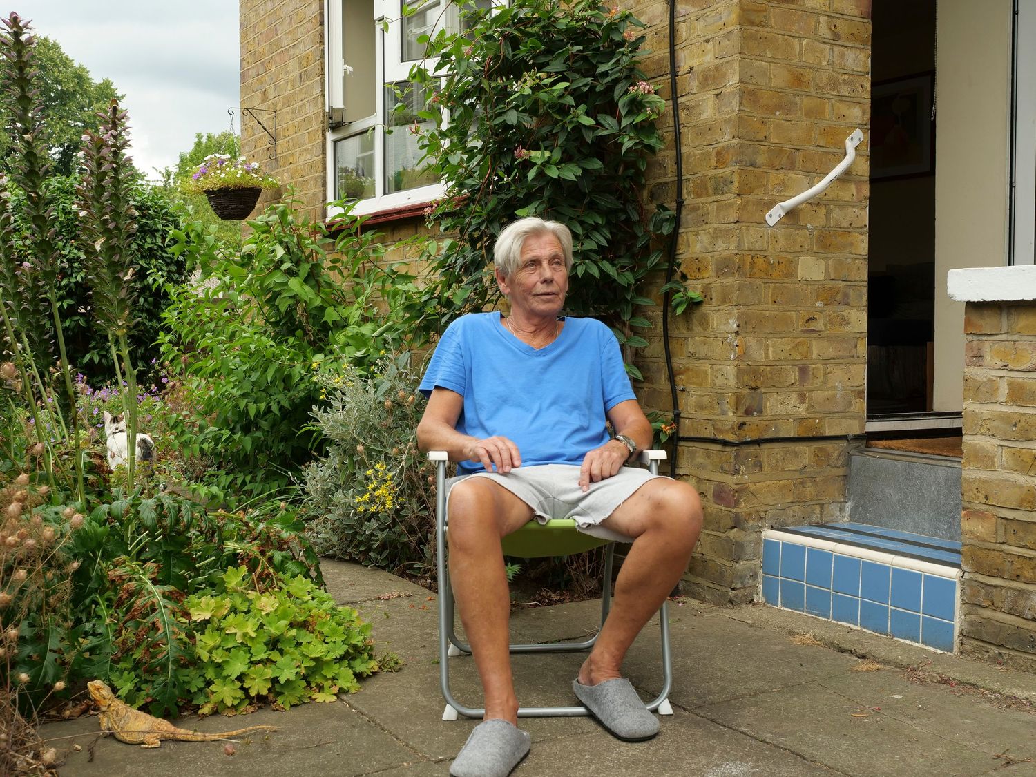 Jim in his garden with his cat and Bearded dragon. Family portraits
Photograph by Danny Elwes