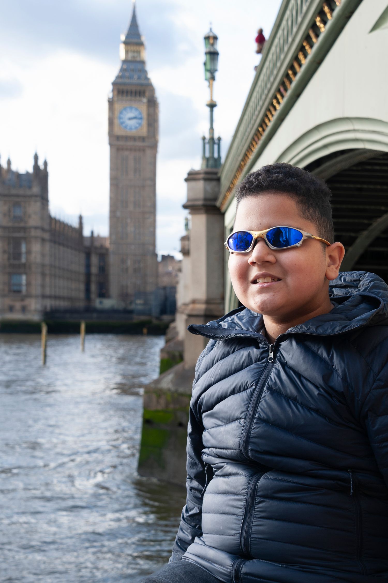 Tourist having been photographed for London Photo Tour with Westminster Bridge with Big Ben in the background.
Photograph by Danny Elwes