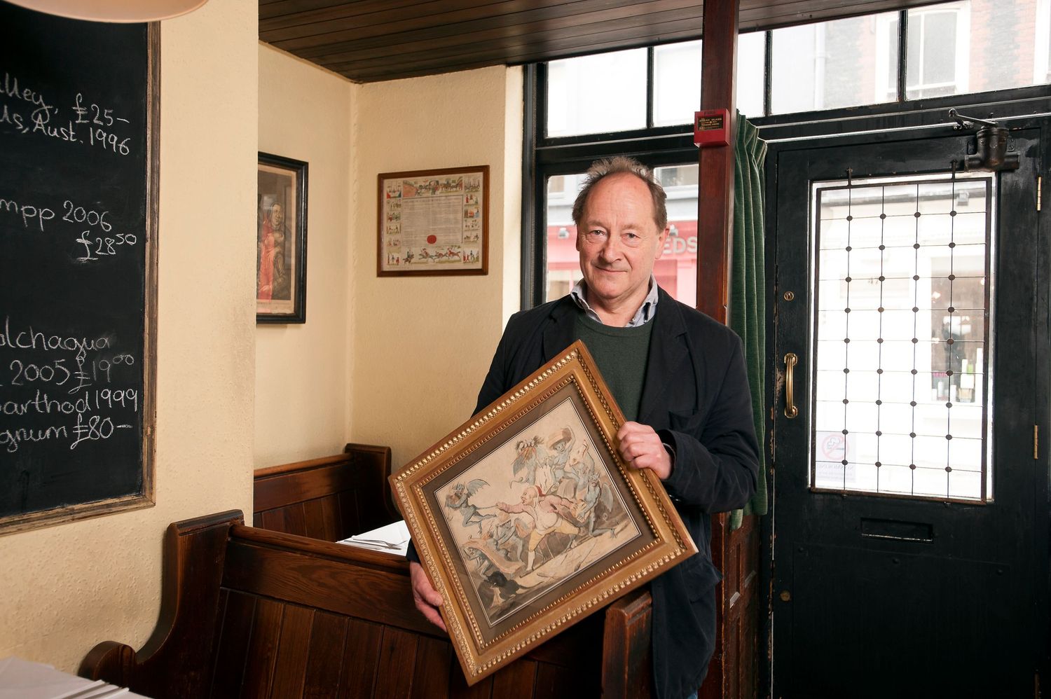 The late Andrew Edmunds in his restaurant: Andrew Edmunds, Lexington Street. Soho with an etching
Photograph by Danny Elwes