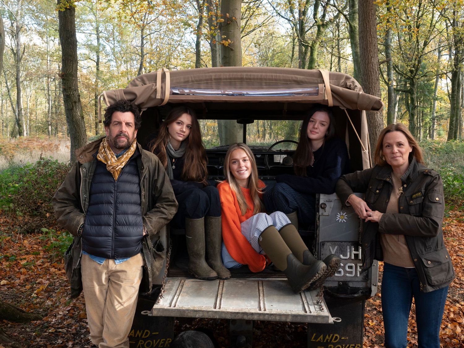 Sisters lounging in back of their old Land Rover vehicle with their Mum and Dad for family photograph for 'Before they Fly the Nest'
