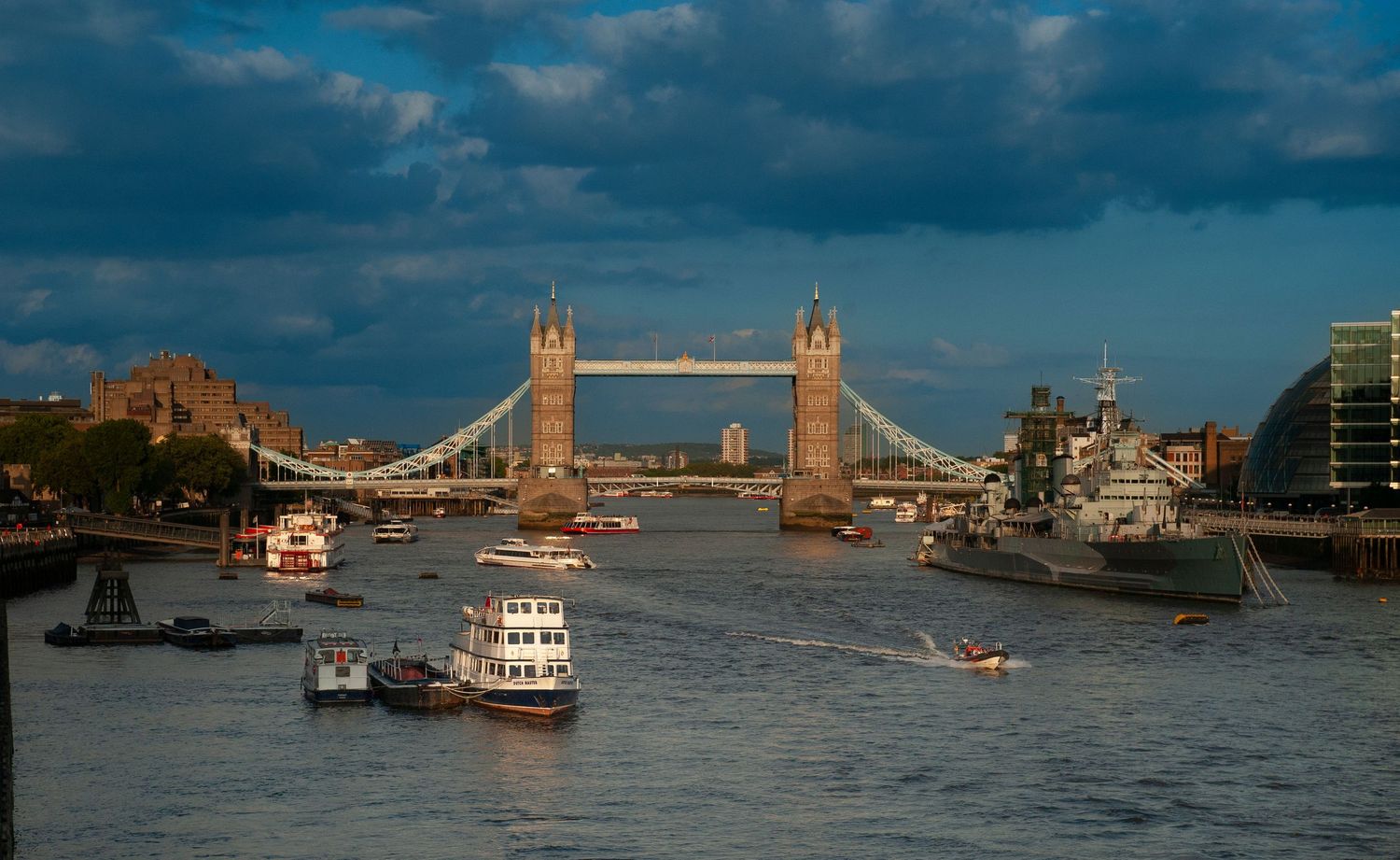 Panoramic view of boats on River Thames with Tower Bridge in the background.
Photograph by Danny Elwes