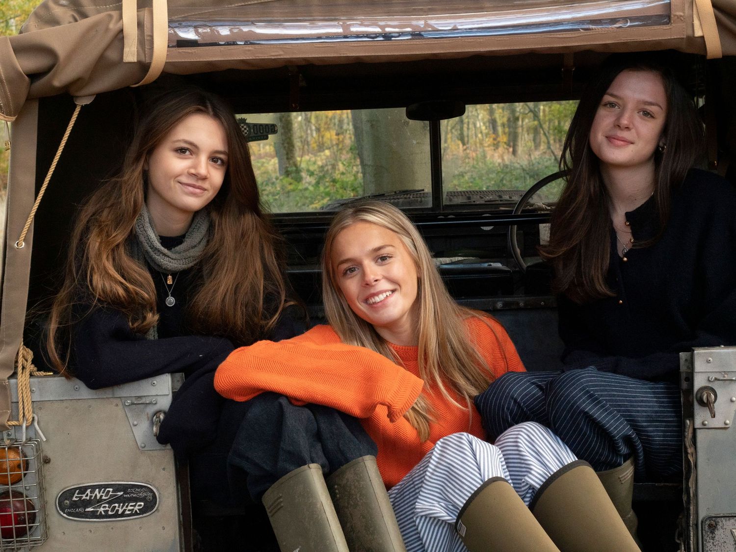 Sisters lounging in back of old Land Rover vehicle for family photograph for 'Before they Fly the Nest'
Photograph by Danny Elwes