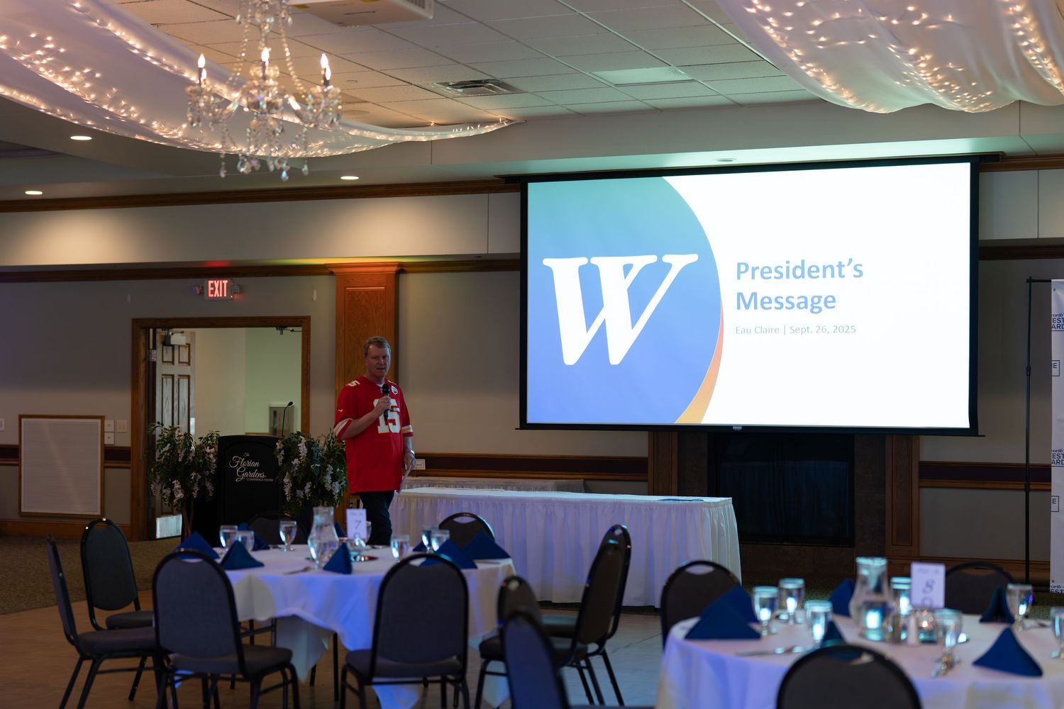 A series of conference rooms with projector screens and chairs arranged for business meetings and presentations.