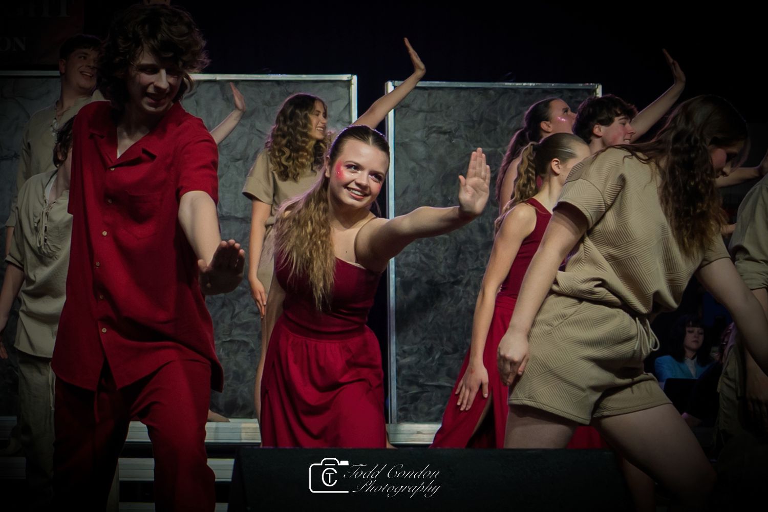 Dance partners perform a dramatic dip move during a passionate ballroom dance performance.