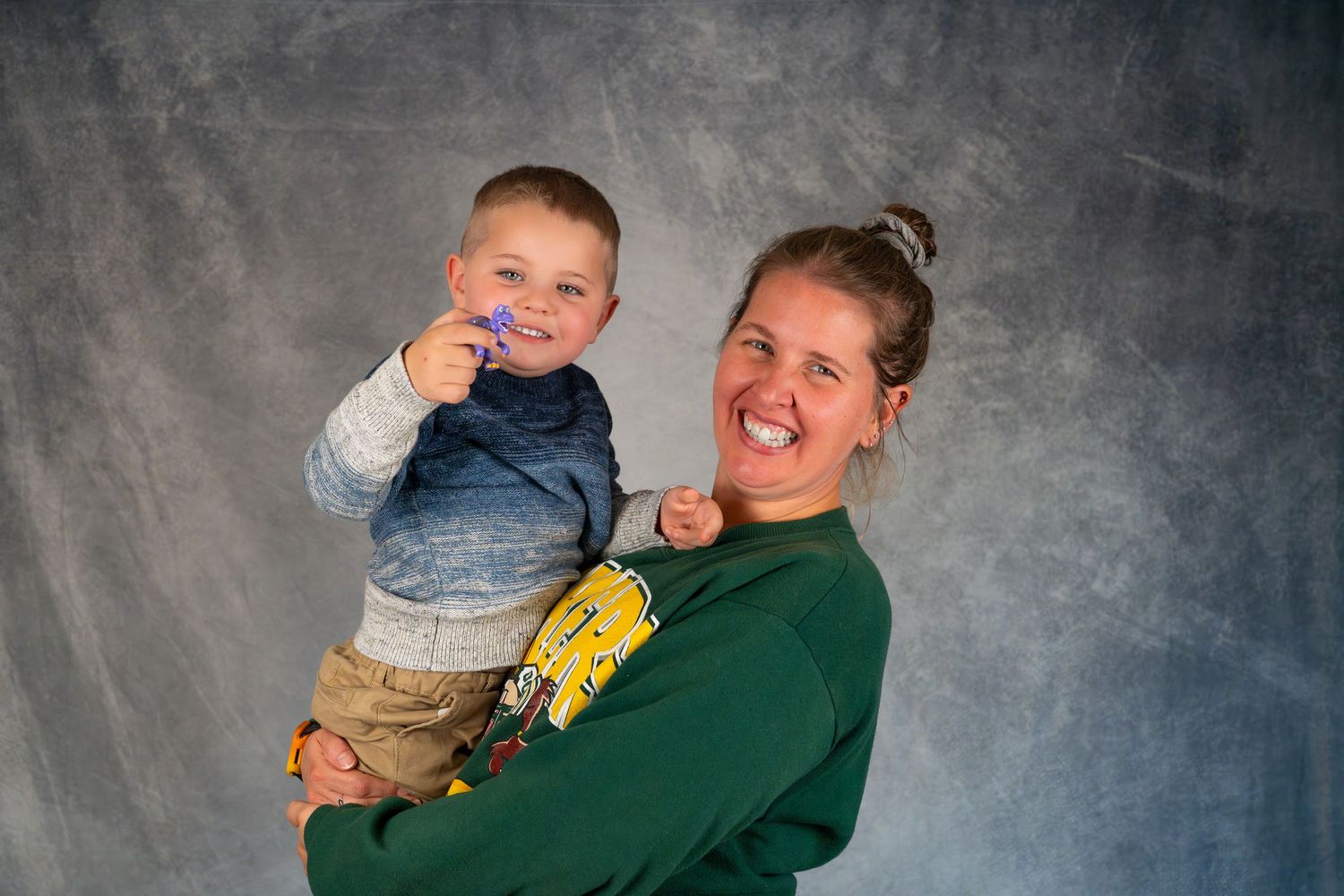 A playful portrait series showing joyful expressions and interactions between two people against a gray studio backdrop.