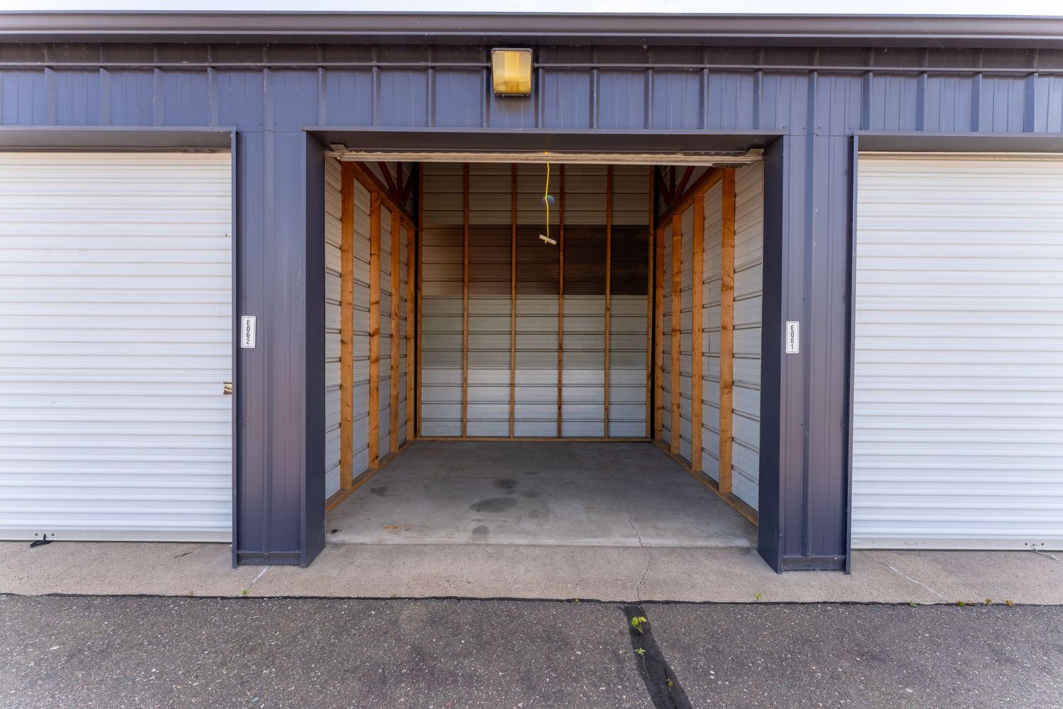 Modern storage unit with roll-up door and concrete floor in a clean, well-lit facility.