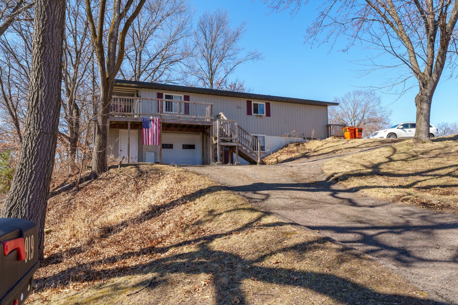 A series of exterior shots showing a residential property with bare trees and sloped terrain in winter.