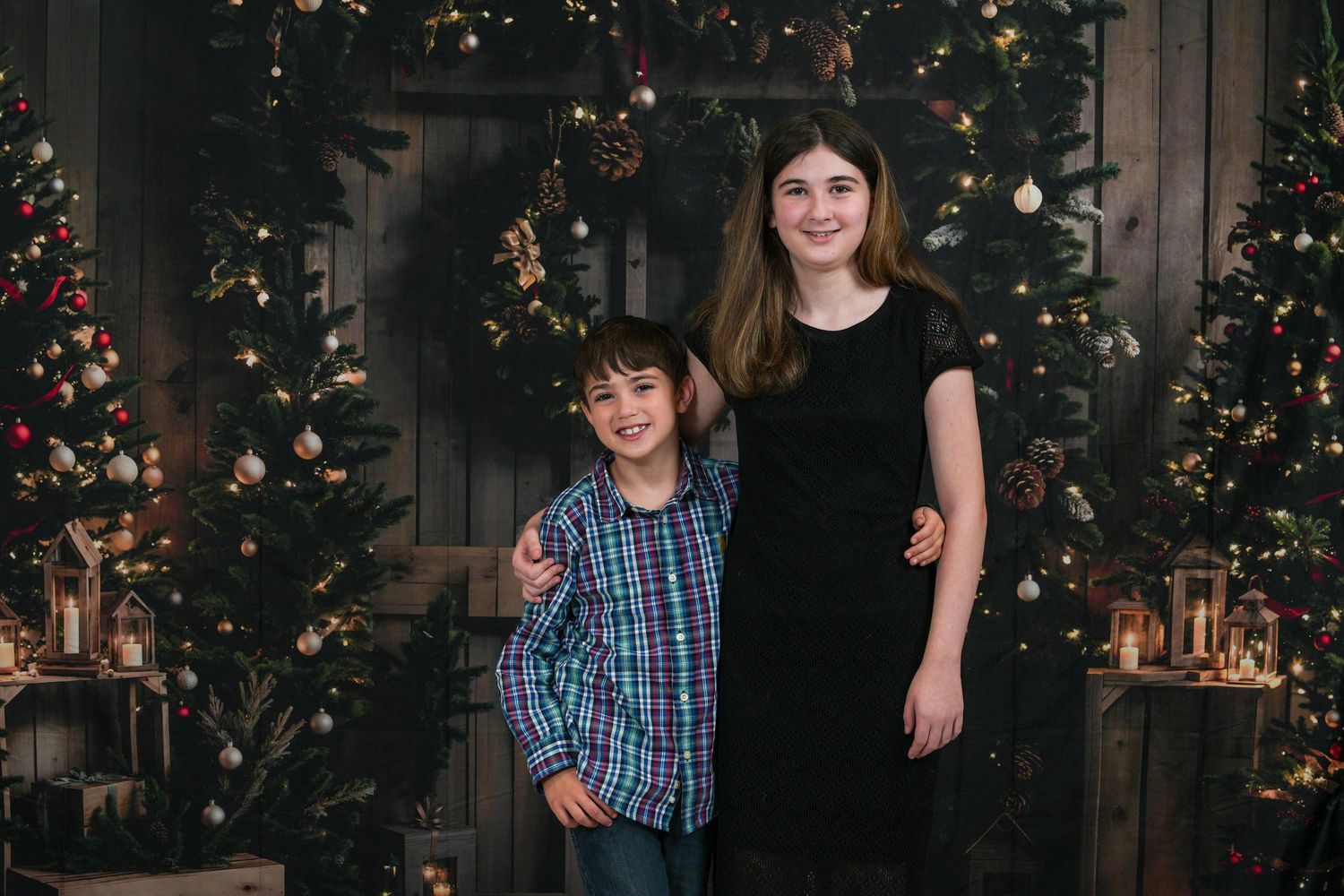 Four holiday portraits show someone in a plaid dress posing in front of a decorated Christmas tree with twinkling lights.