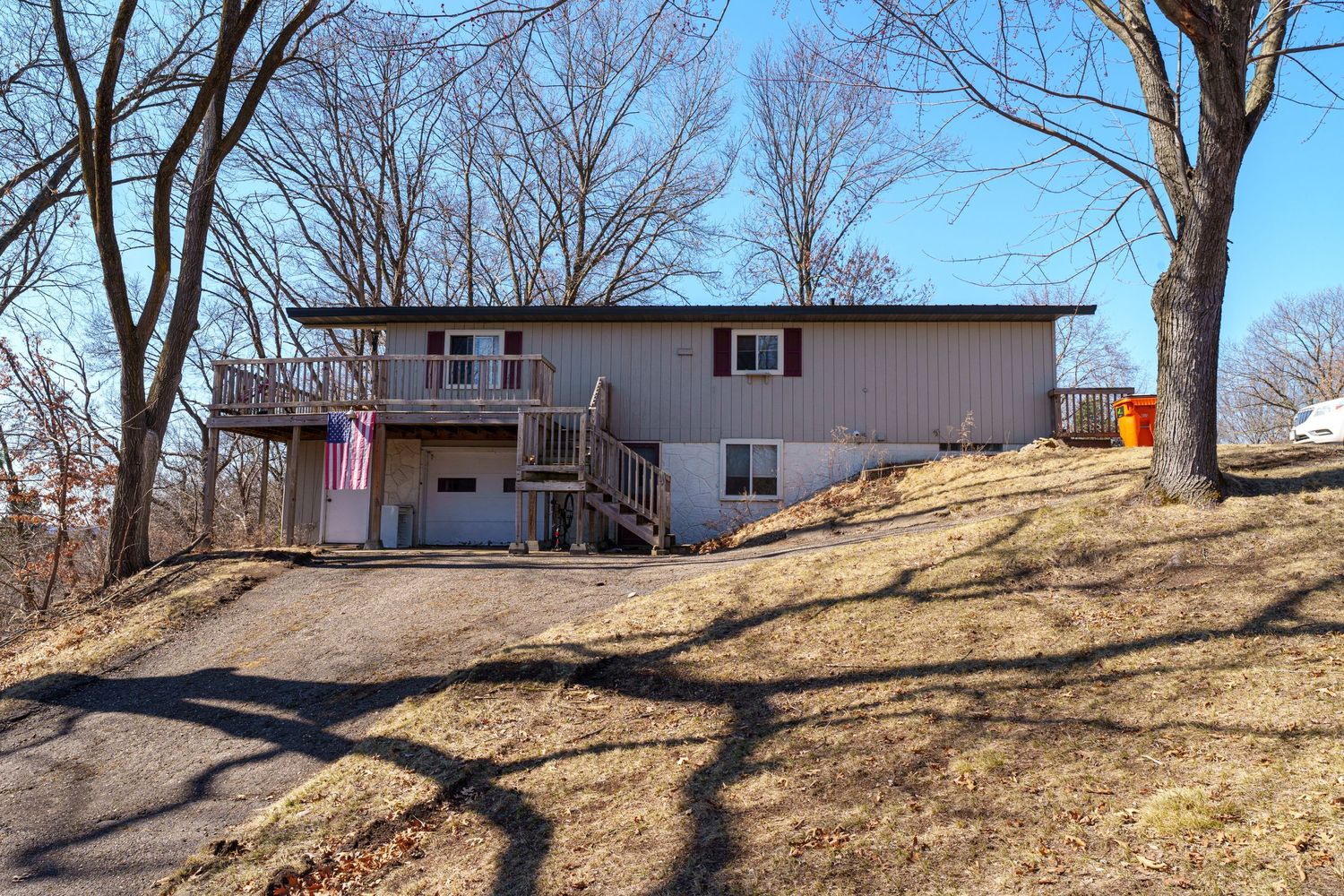 A series of mobile homes sit on a hillside with bare trees in winter, showing multiple angles of the residential area.