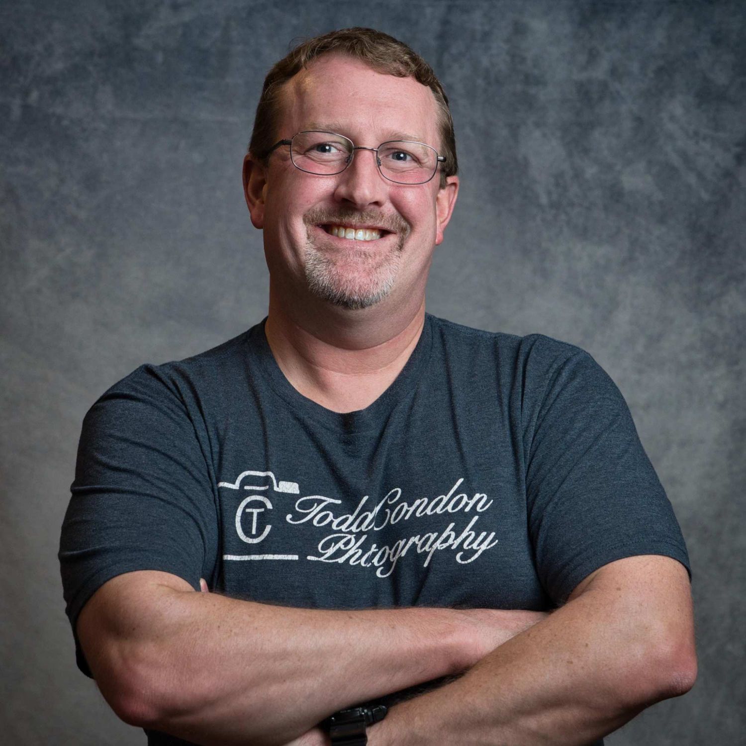 Studio portrait series showing photographer in casual dark clothing against gray background.
