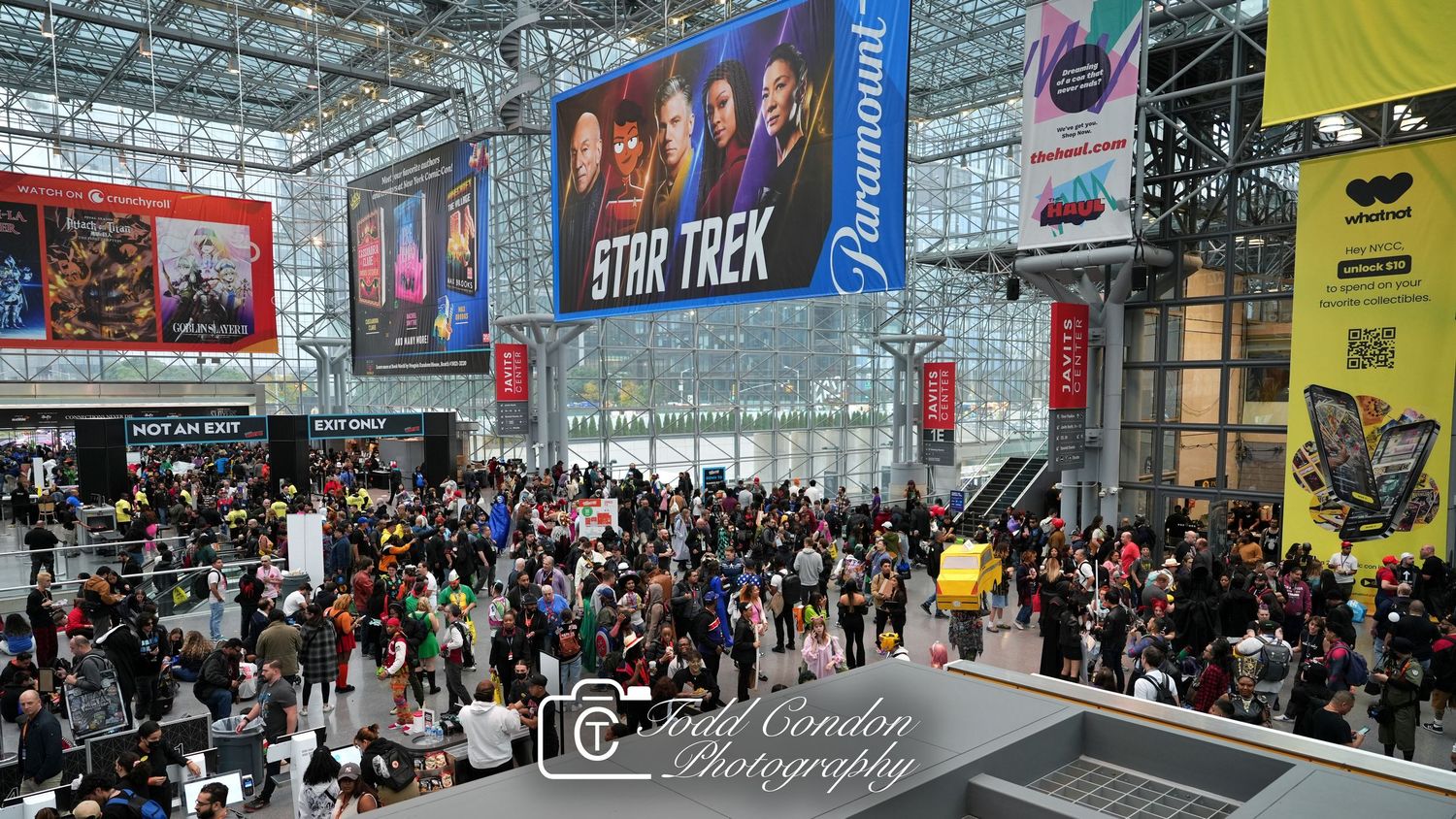 Crowded Star Trek exhibit at a Paramount convention center with large banners and diverse attendees filling the expansive hall.