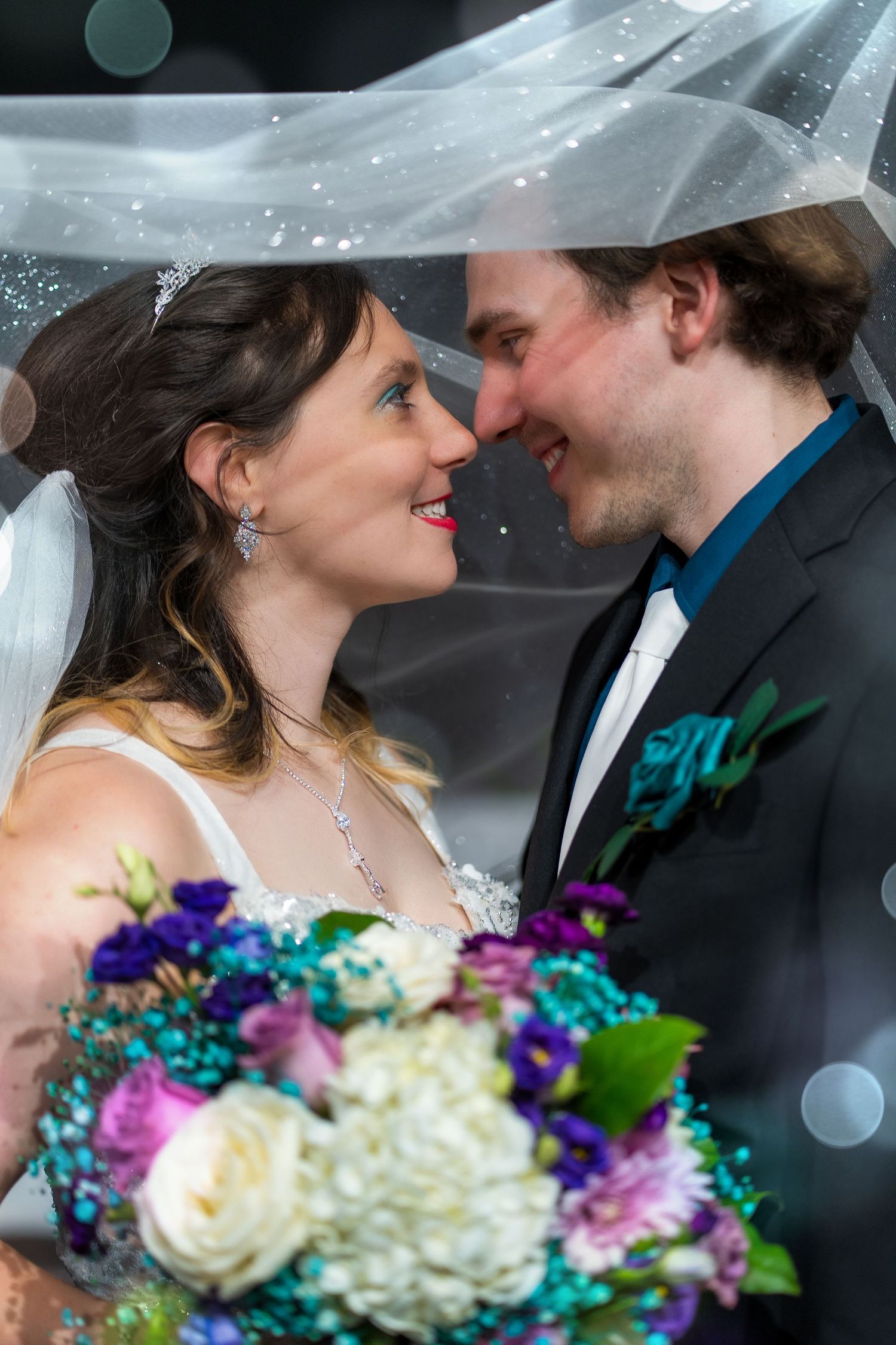A romantic wedding sequence shows a couple sharing intimate moments under a veil with colorful purple and white bouquet flowers.