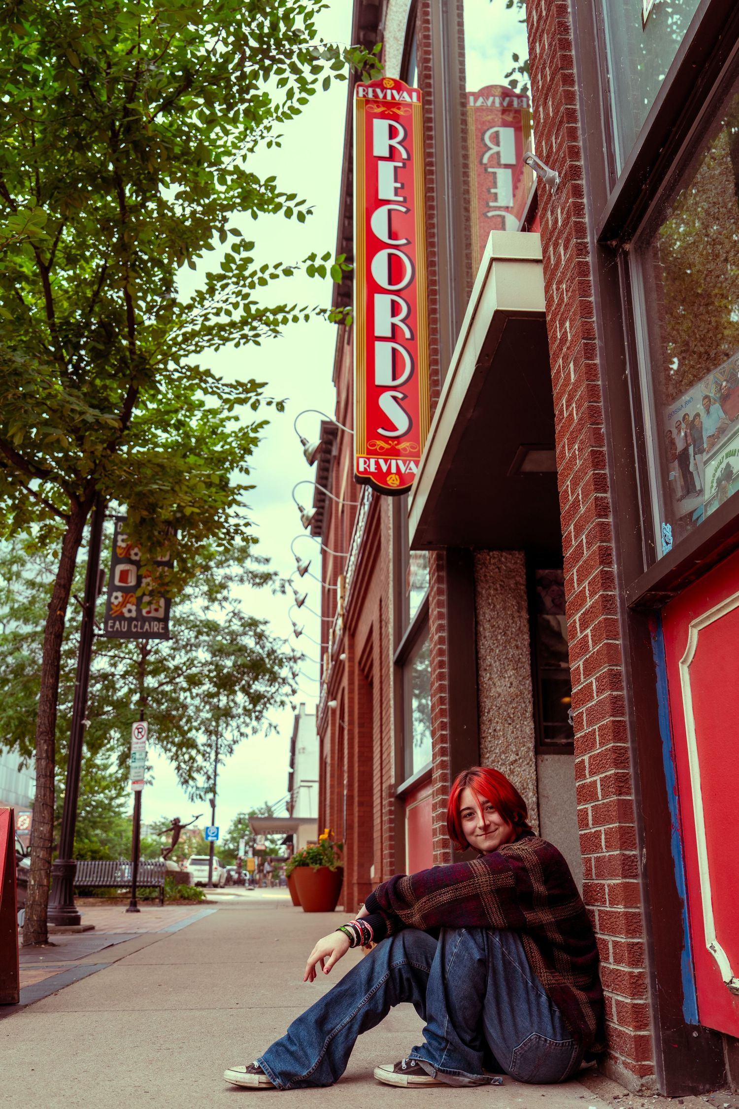 A sequence of photos showing a person lying down on a sidewalk next to a brick storefront with red signage.
