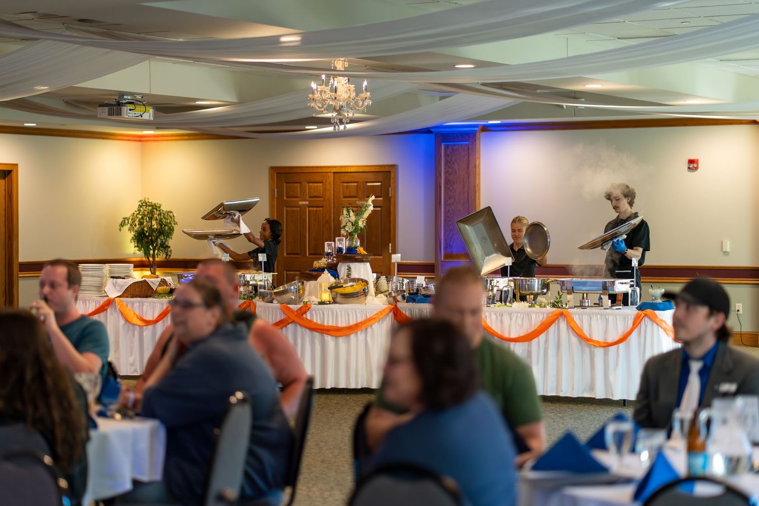 A sequence of blurry wedding reception photos showing dancing and celebration in a banquet hall with decorative lighting.