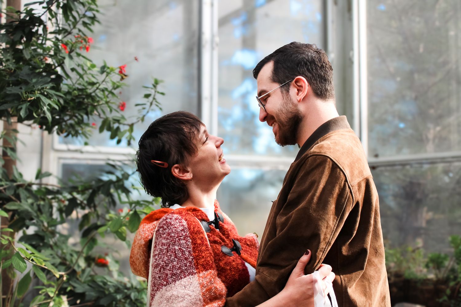 Couple holding each other after proposal at the butterfly pavilion in Colorado