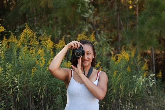 The photographer posing with her camera