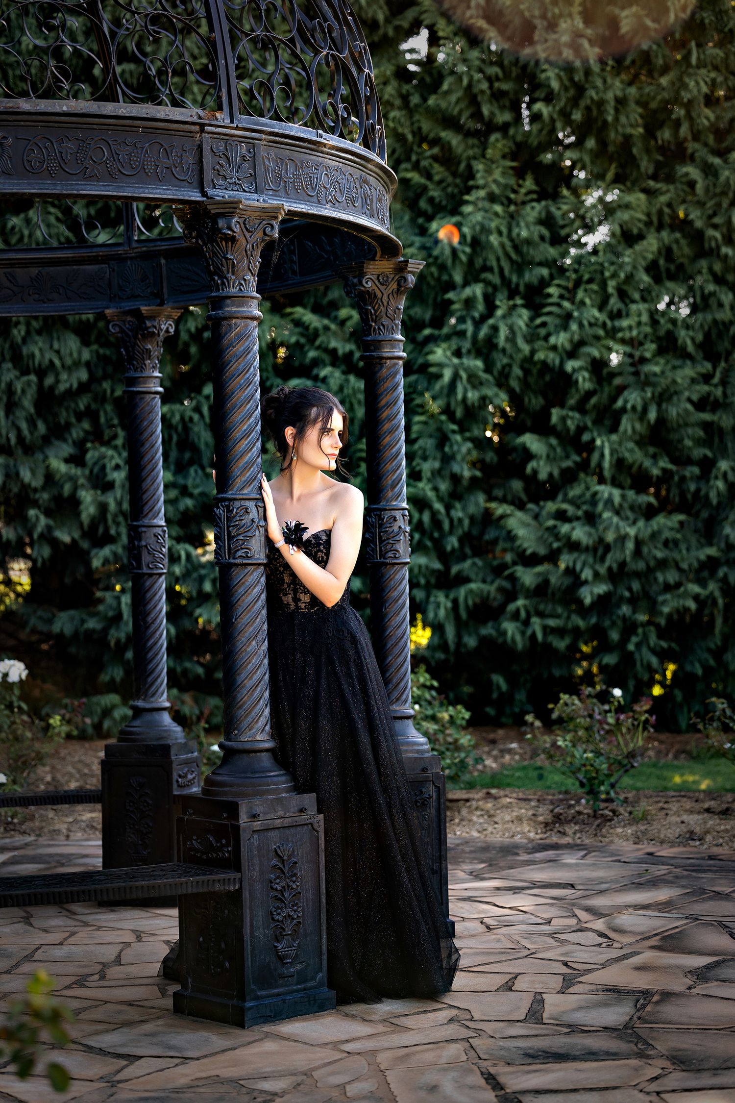 Elegant portrait session featuring ornate iron pillars and stone pathway in a garden setting.Toowoomba Photographer Toowoomba Newborn Photog